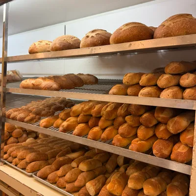Bread loaves and rolls lining the shelves
