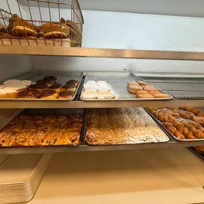 Donuts and sweet pastries on bakery trays